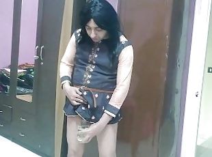 sissy crossdresser femboy peeing in a drinking glass and it will be full.